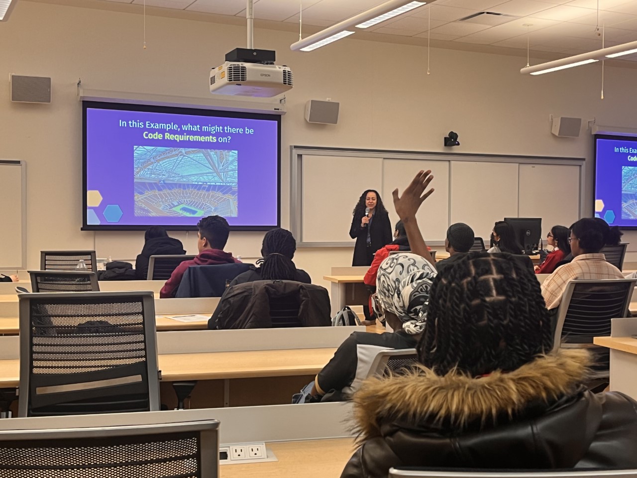 Students in an classroom listening to a speaker