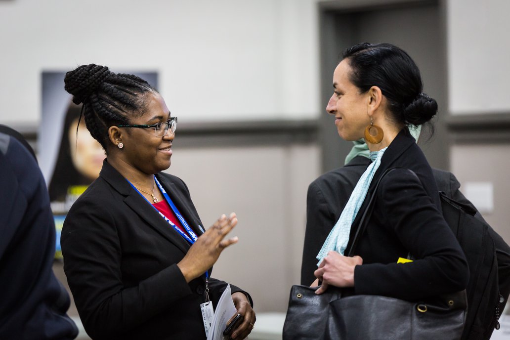 Photo of two people speaking
