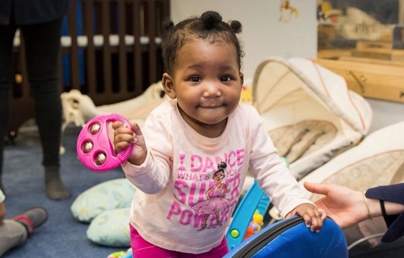 Photo of little girl with toy