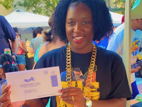 a woman holding up a envolope