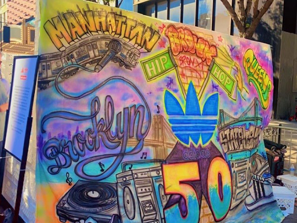 a colorful, painted cloth hanging at the street