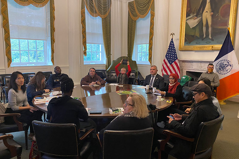 CEC & MOIA Commissioners with reporters.