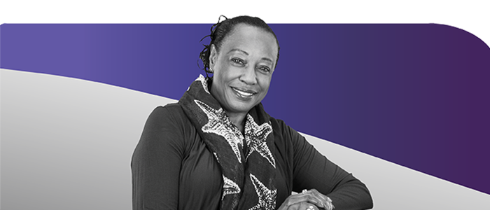 Older woman with neck scarf and hands folded, smiling Older woman with neck scarf and hands folded, smiling