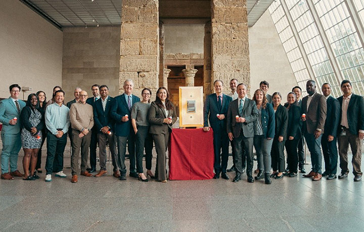 First Deputy Chavez and several representatives from DCAS, the MET and NYPA surround a giant light switch on a red table.
                                           
