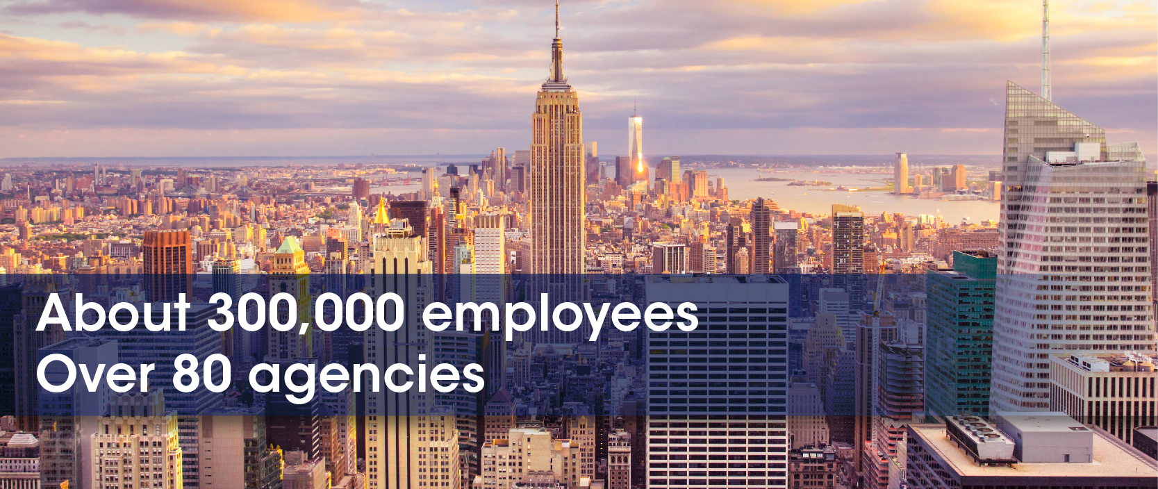 New York City buildings as the sun sets. Text overlays the photo which says: About 300,000 employees. Over 80 agencies.