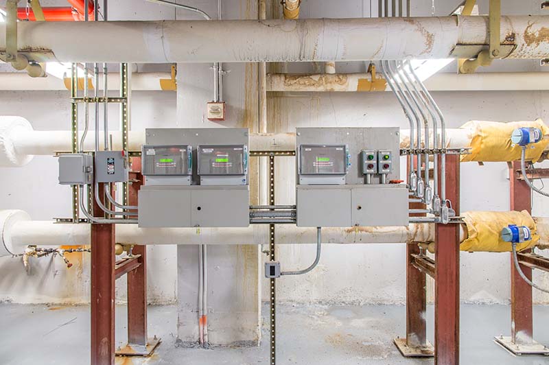 Three real time meters measuring electricity use in a boiler room of a public building. Three real time meters measuring electricity use in a boiler room of a public building.