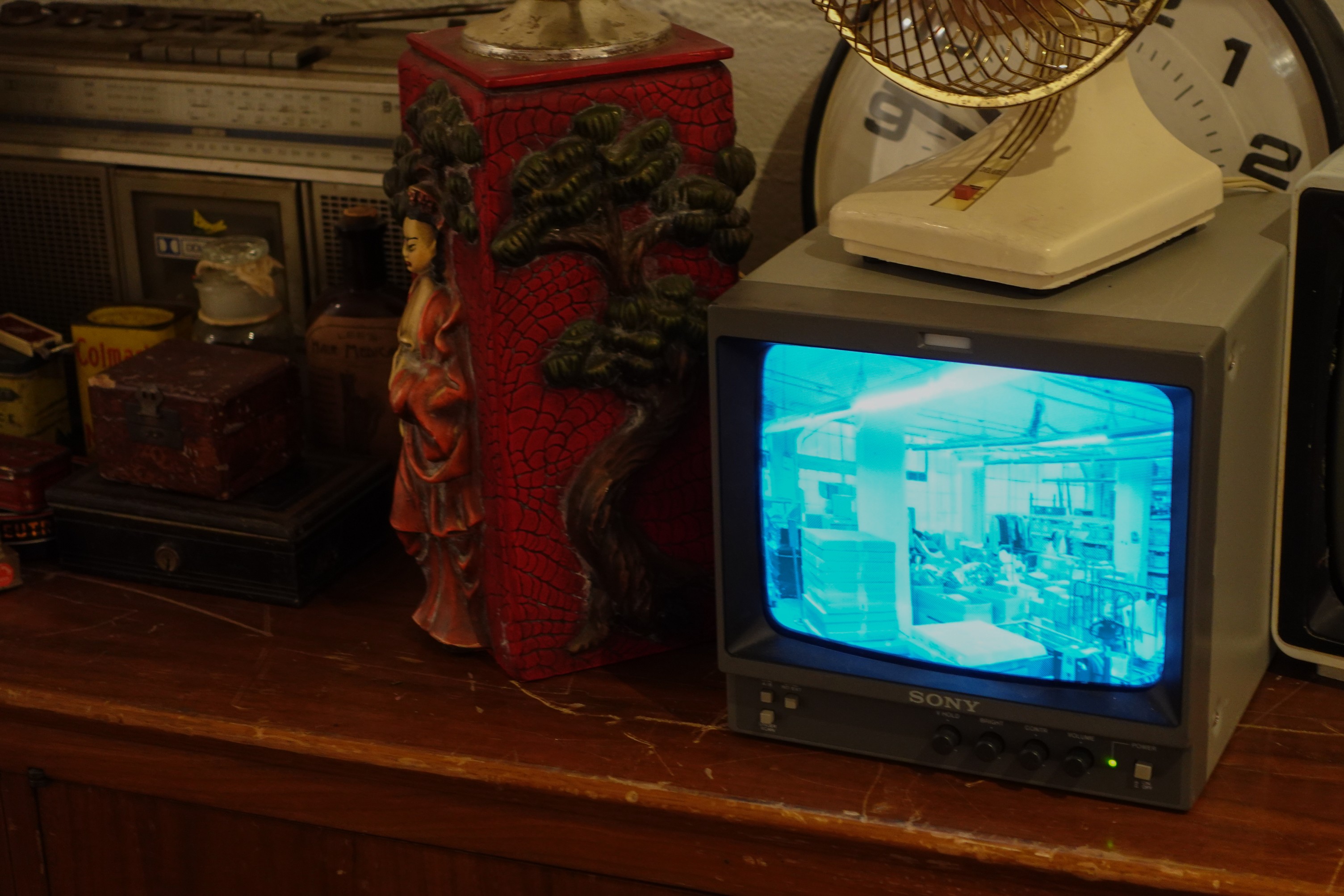 A video of the MFTA warehouse plays on a small television in the gallery.