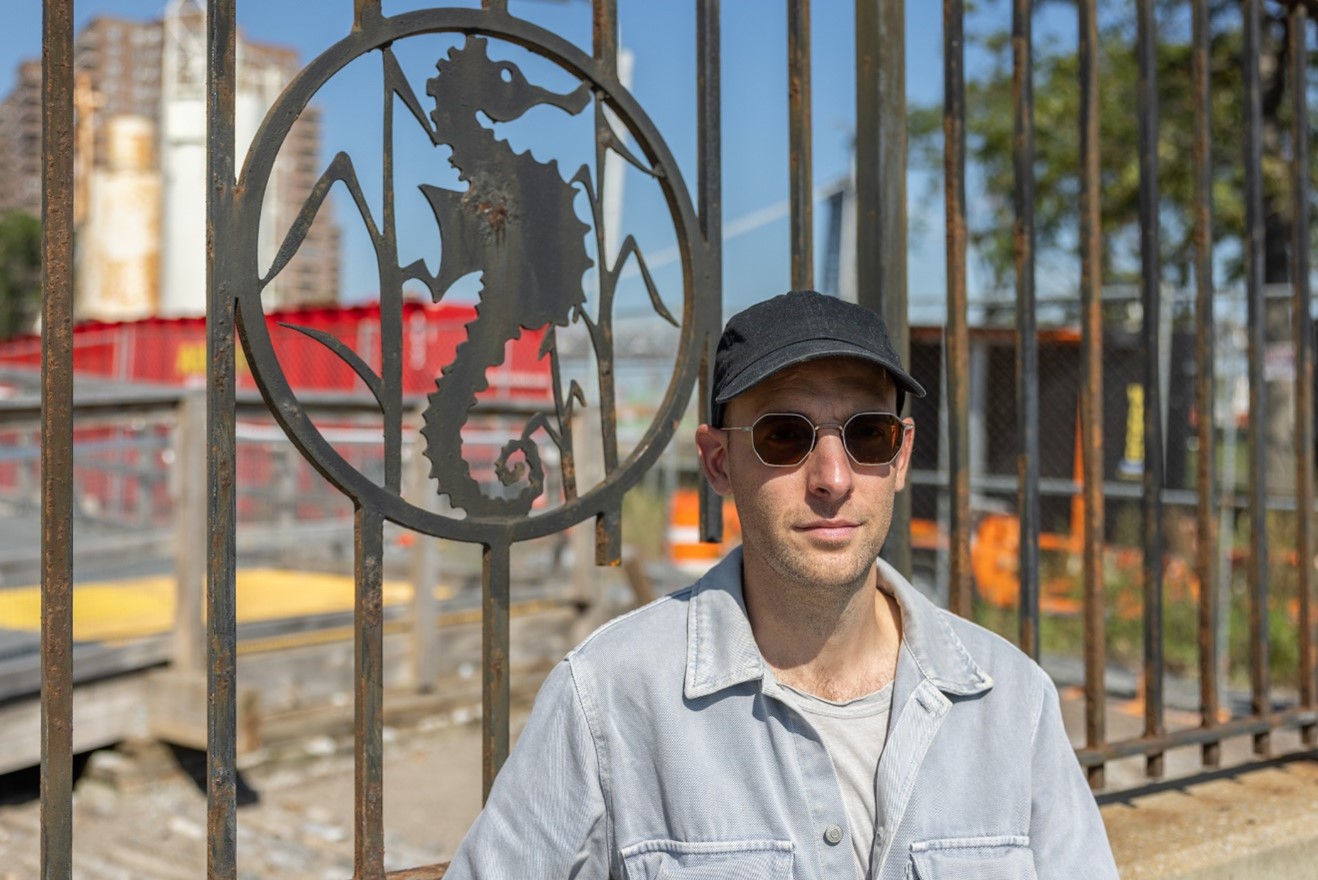 Artist in front of FDR Drive fence