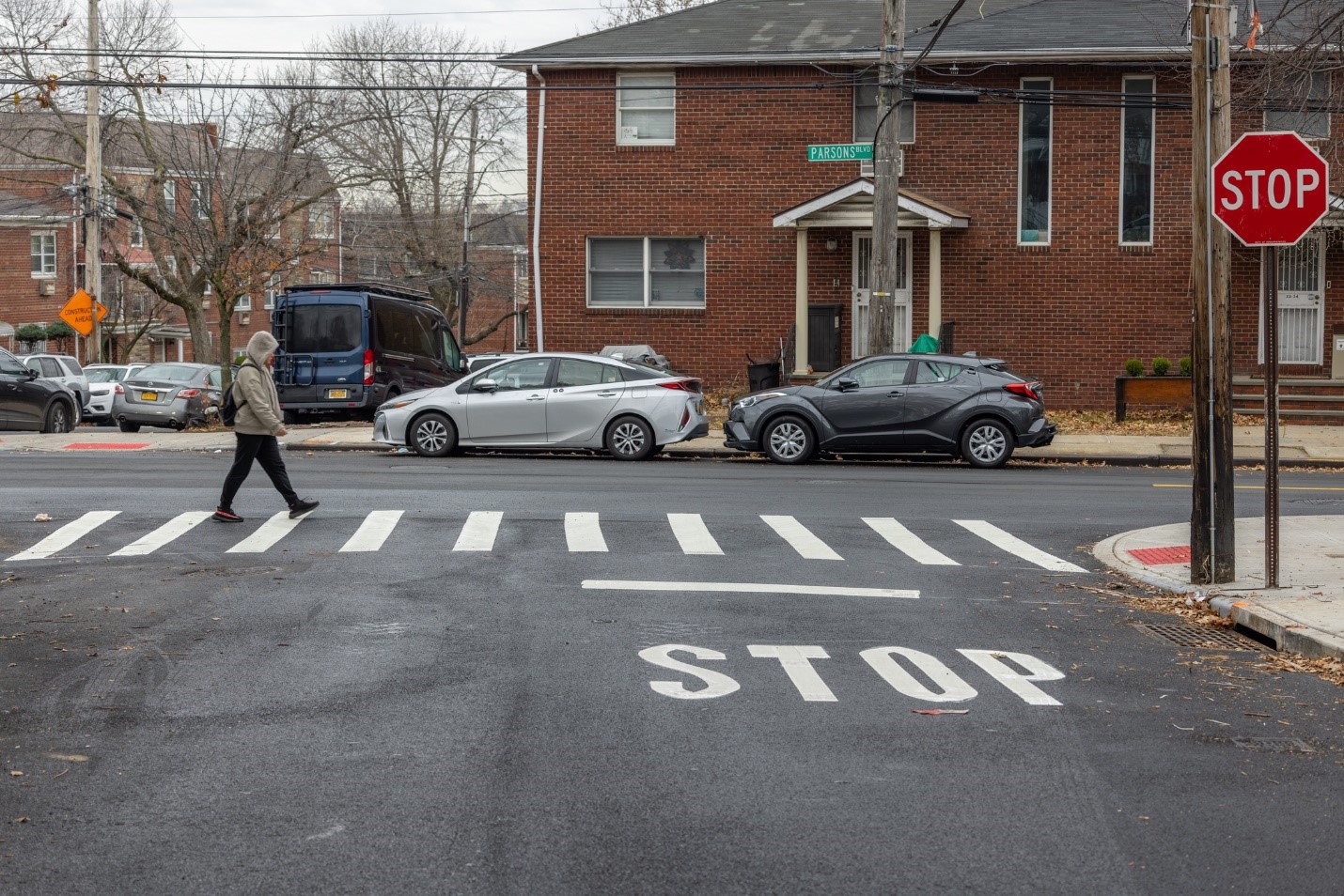 a pedestrian crossing the street
