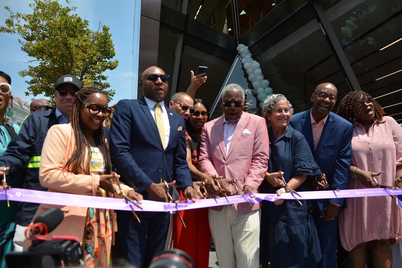 elected and city officials cut the ribbon to celebrate the new library opening
