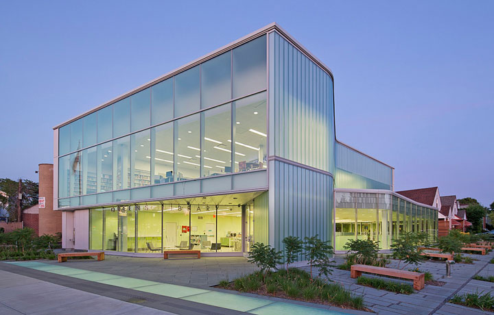 A view of the front of Glen Oaks Library at dusk.