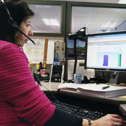 A customer service representative at her work desk