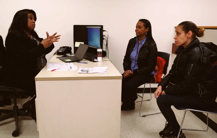 DHS employee attending to clients