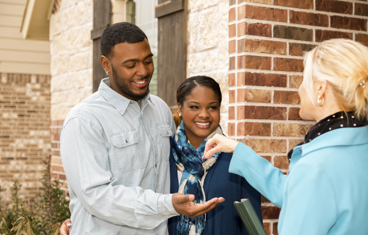 Young couple receiving a pair of keys
