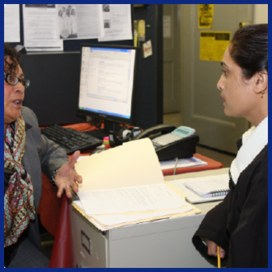 two women have a conversation in an office