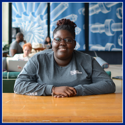 A young female with blue shirt posing for picture. The Learn & Earn Program