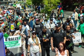 New Yorkers walking in the 50th Anniversary NYC Cannabis Parade and Rally.