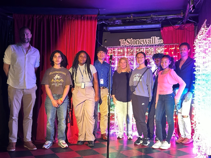 SYEP Pride participants gather on stage at the Stonewall Inn for a photo with Acting Executive Director of the Unity Project Ronald Porcelli and Co-Owner of the Stonewall Inn Stacy Lentz.