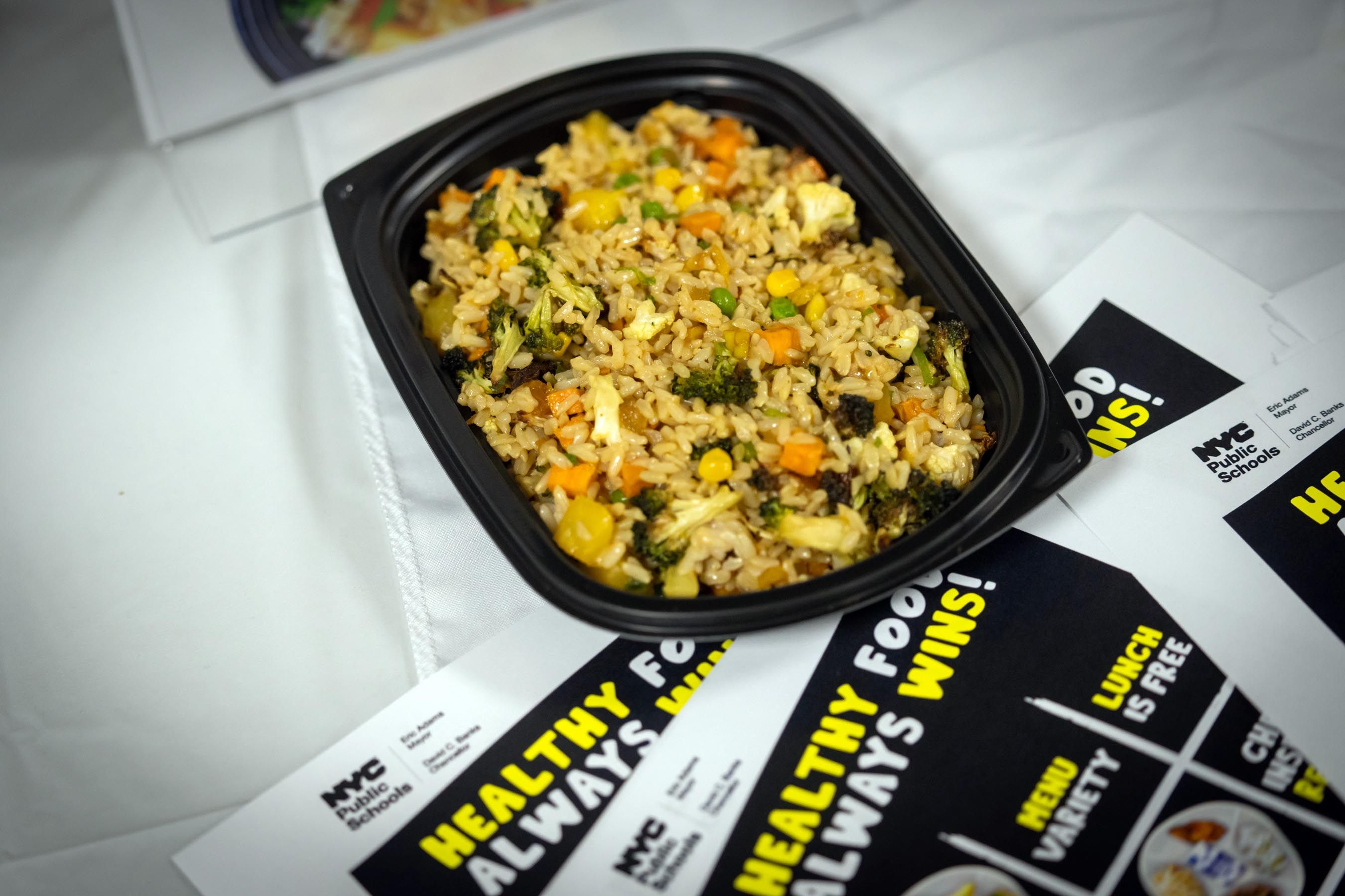 Image of rice in a to go bowl with Healthy NYC content around it.