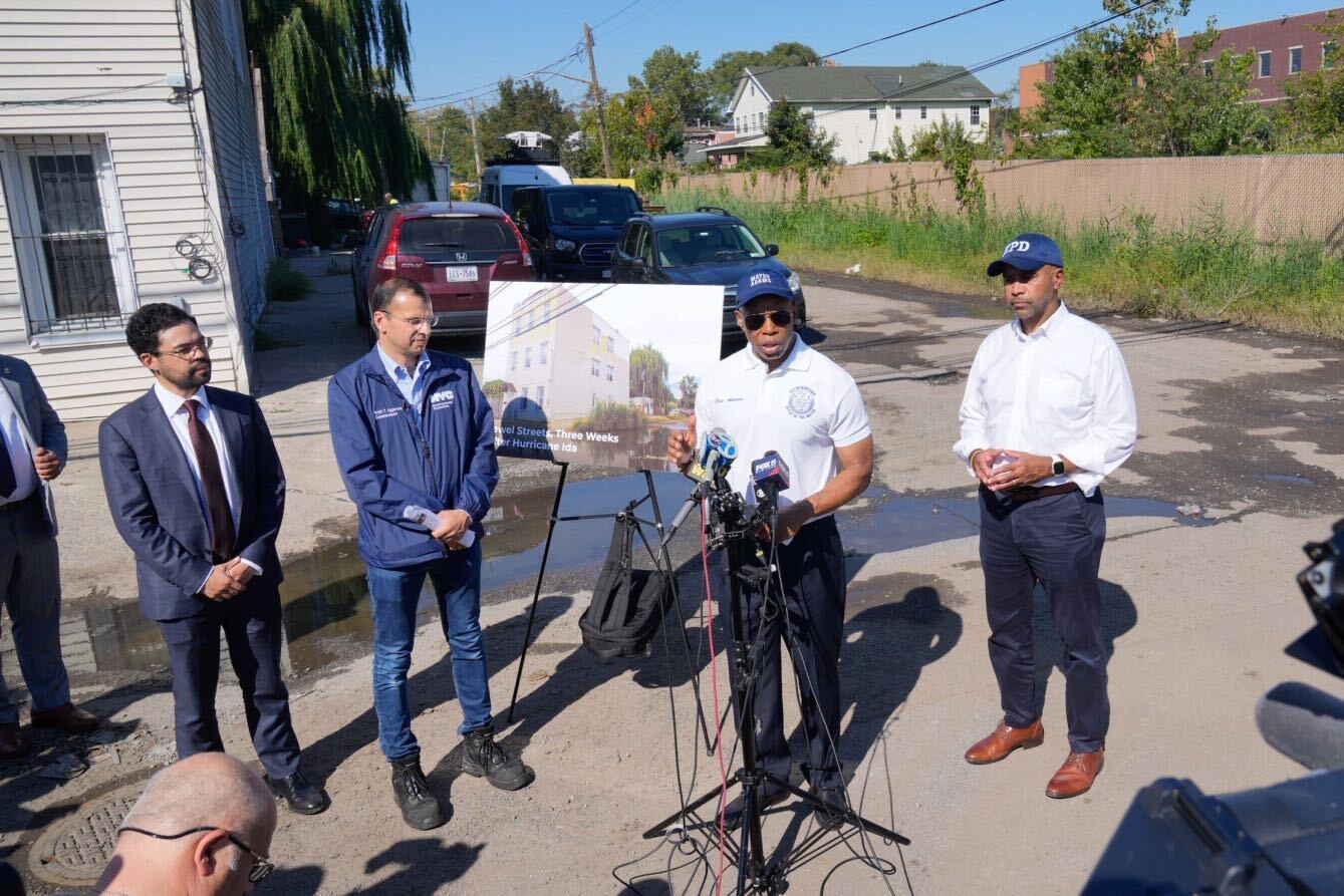 null mayor adam accompanies by other officials is seen giving a public press briefing one the street