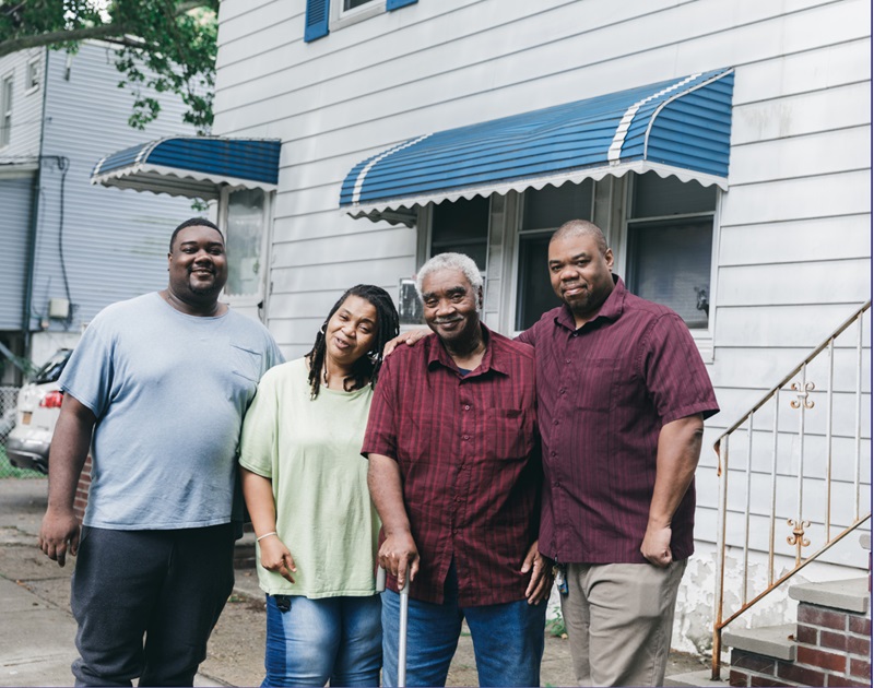 4 people in front of a house
