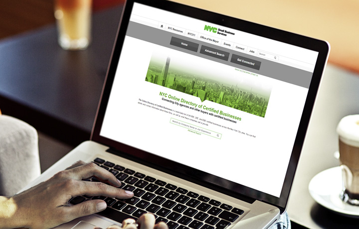 image of hands on a laptop with a screenshot of the online directory
                                           