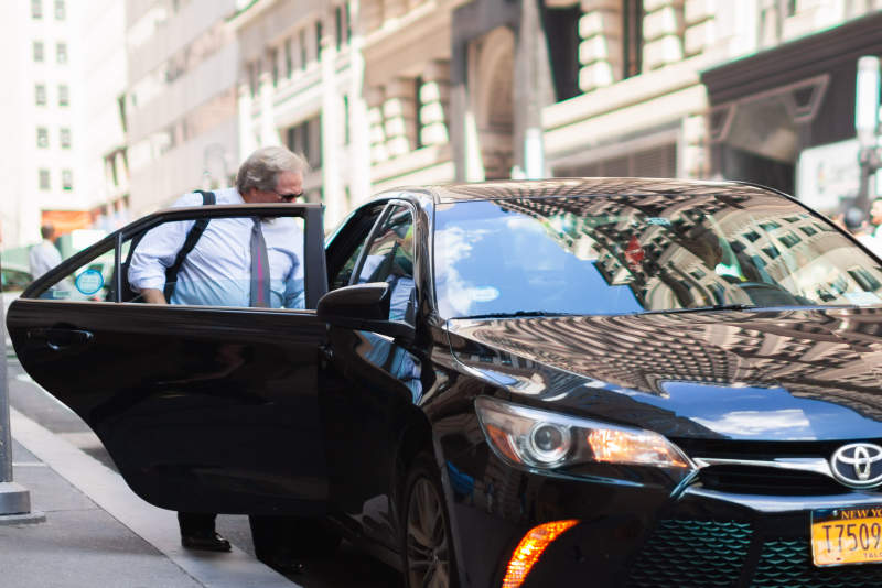 Man entering a black car