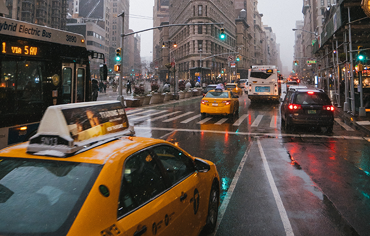 Yellow taxis in city street with other vehicles