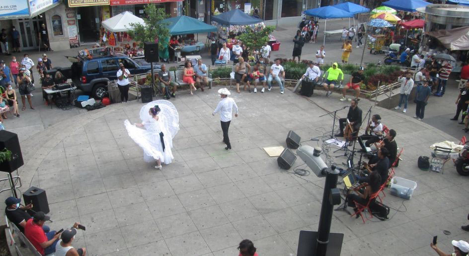 Dancers and musicians perform at an event on Corona Plaza in Queens
