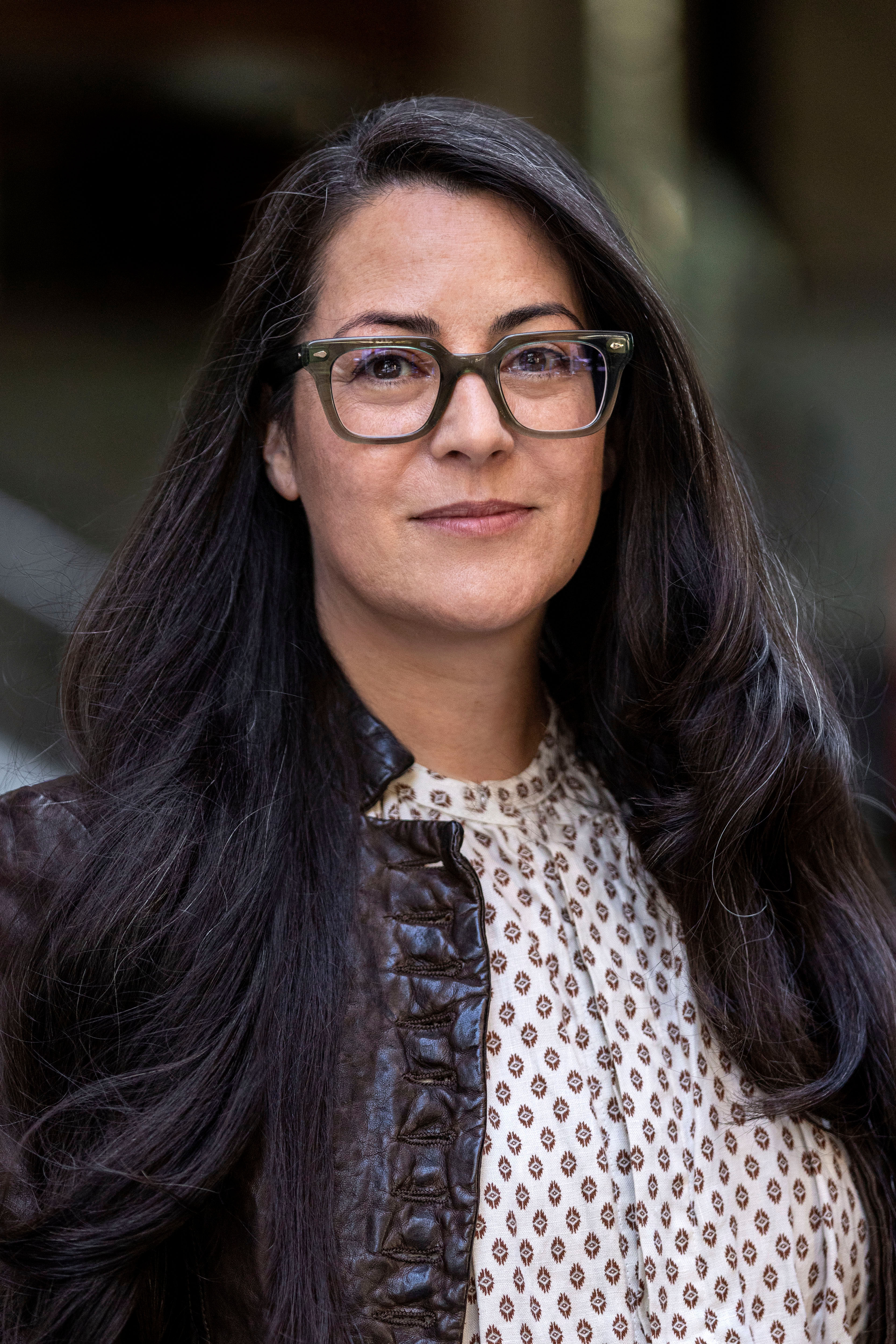 Nicole Garcia, Queens Borough Commissioner Portrait of New York City Department of Transportation's Queens Borough Commissioner Nicole Garcia with long dark hair, wearing glasses and a brown jacket over a patterned button down shirt.