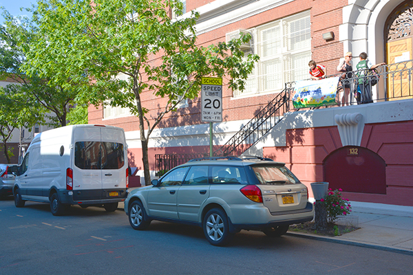 20 mph School Slow Zone sign on street in front of a school