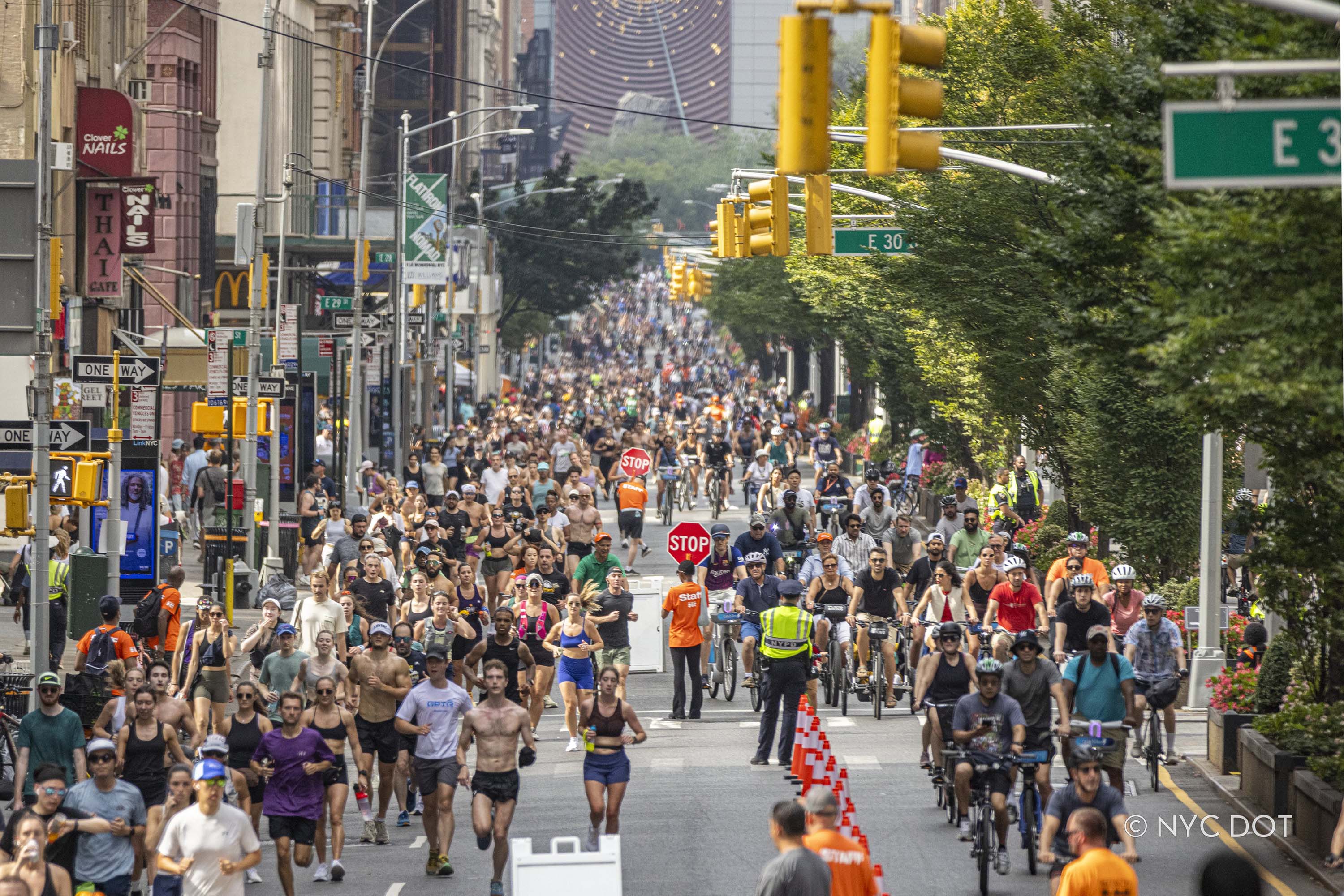 People walking, running and biking take over a car-free Park Avenue during Summer Streets. 
