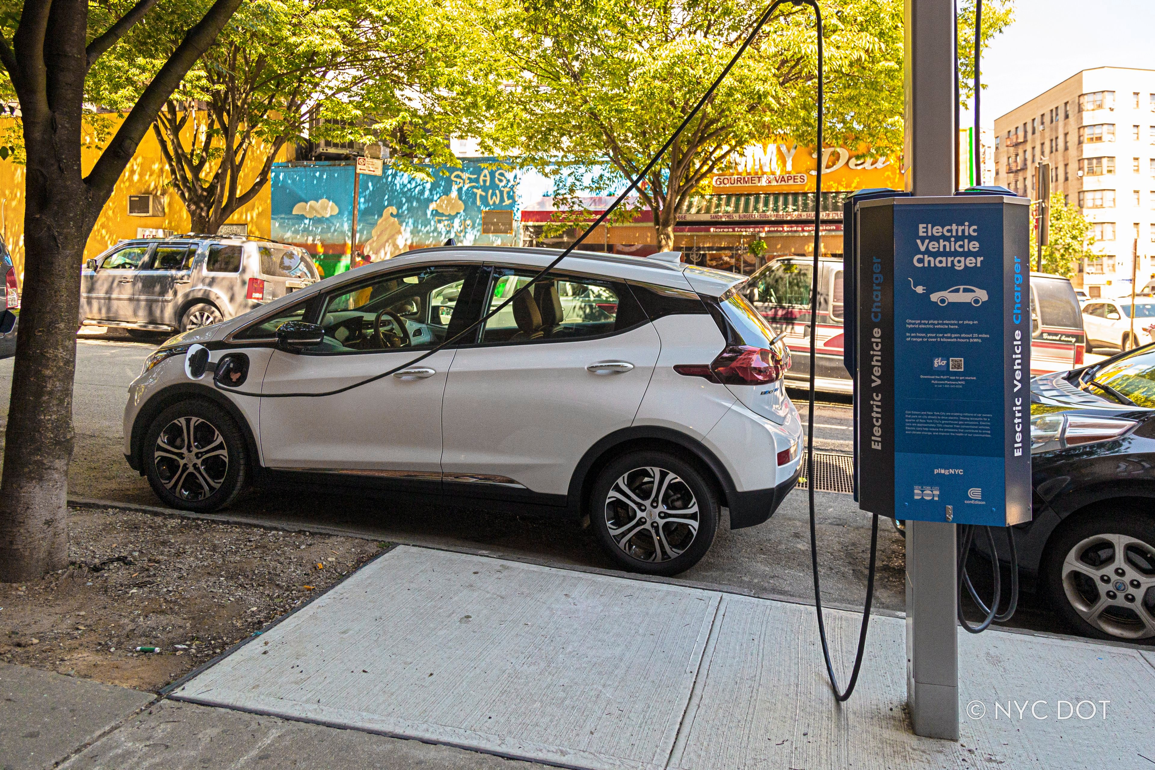 A car plugged into a curbside electric vehicle charger in the Bronx. Credit: NYC DOT