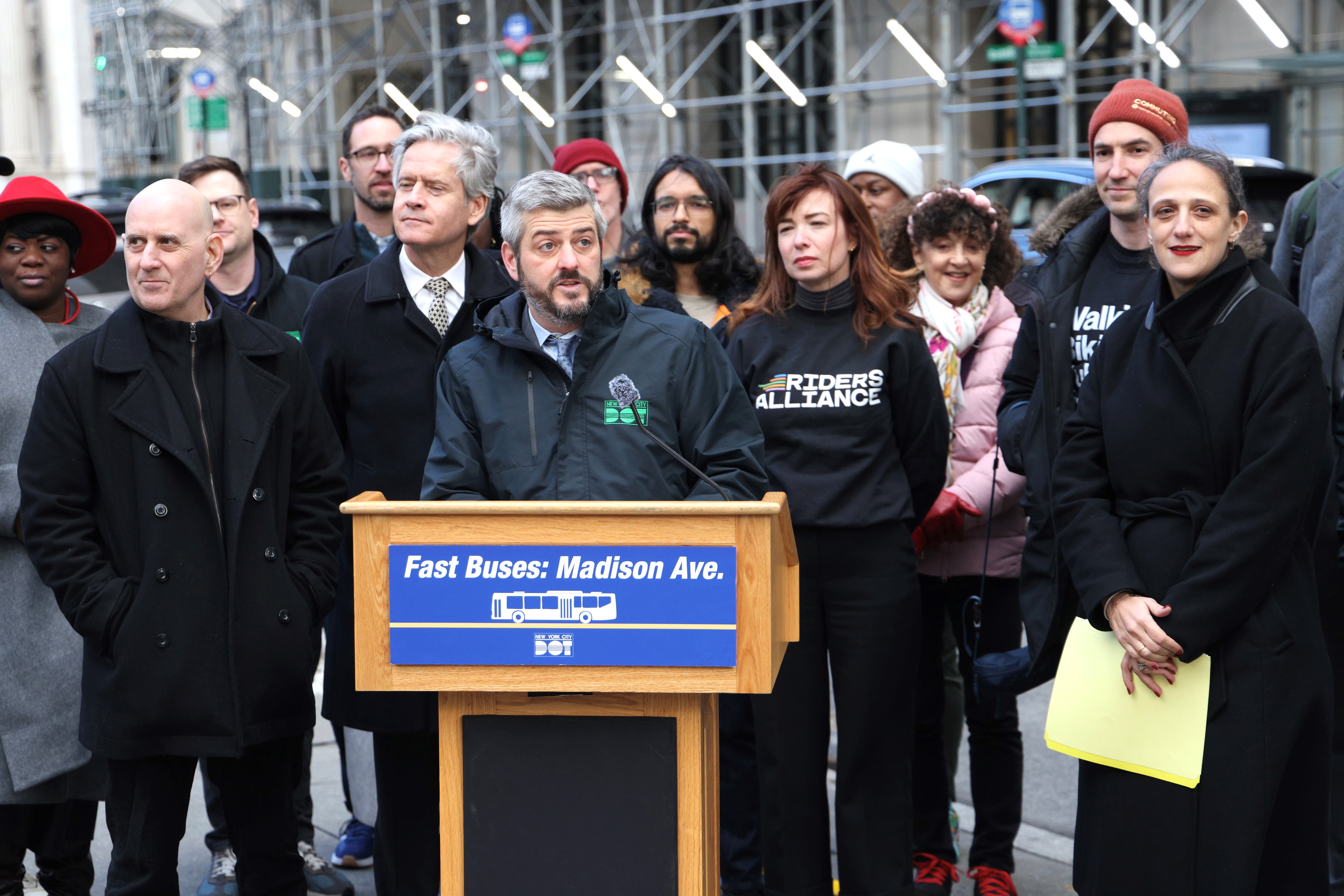 Image of Commissioner Mike Flynn speaking at an announcement about the completion of a long-stalled street redesign, including extended double bus lanes.